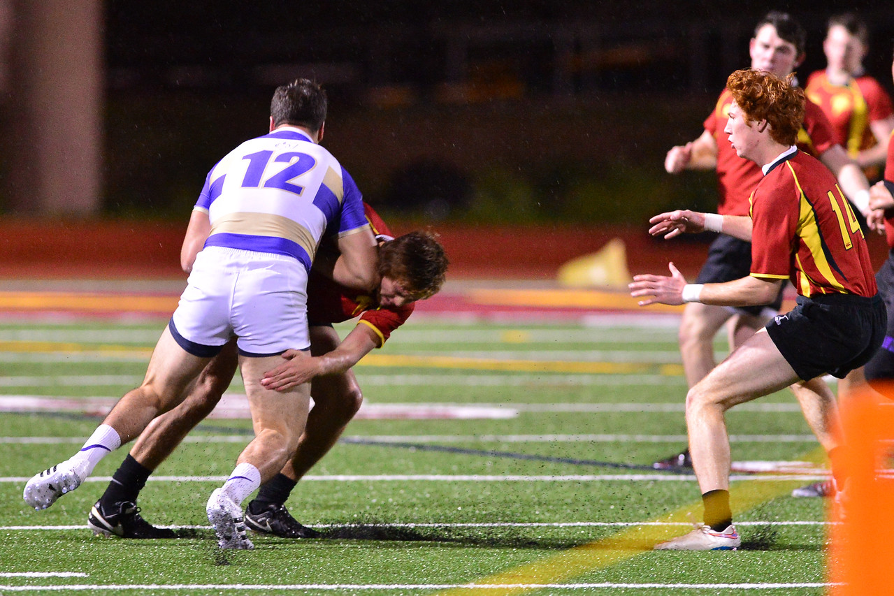 Andrew Alves for St. Augustine rugby tackled by Torrey Pines defender. Anna Scipione photo.