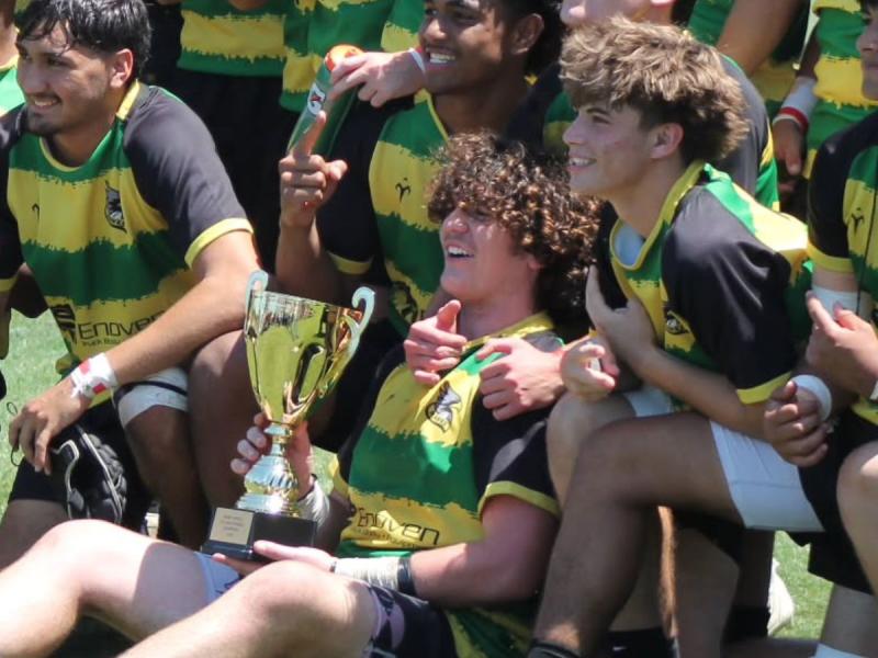 Sam Enochian with the Carmichael Hawks and their 2026 Northern California Gold championship trophy.