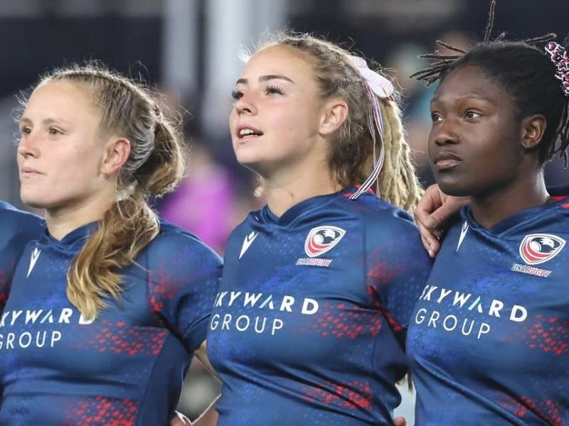 Cass Bargell, Bella Vogel, and Erica Coulibaly stand for the anthem.