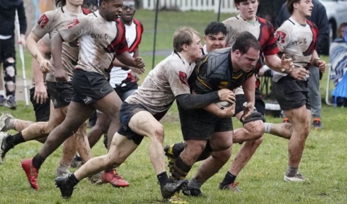 Aspetuck prop Joseph Coscia relished the wet conditions and he trucks on through some Berks defenders.