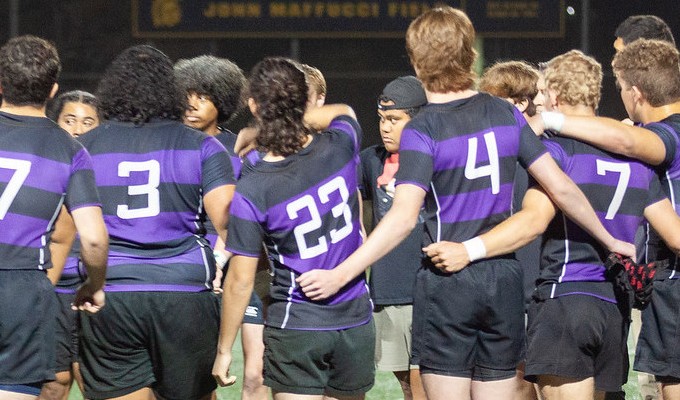 Carlsbad players huddle up. Janell Riley photo.