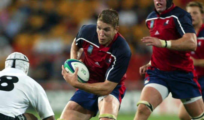 Dan Lyle takes on a Fijian defender in the 2003 Rubgy World Cup. Photo Rugby World Cup.