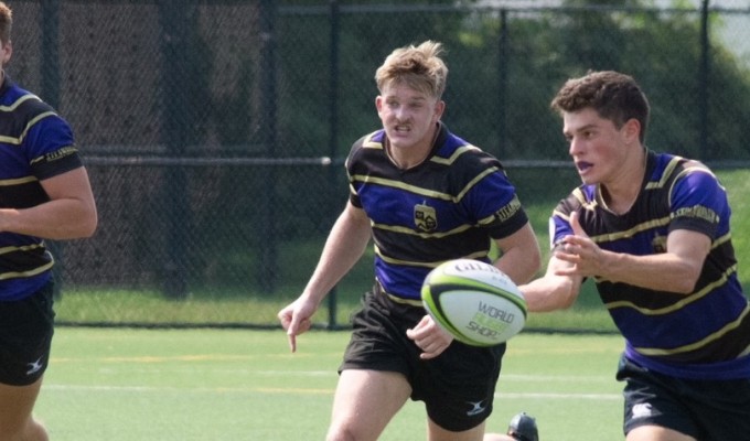 JMU flyhalf Dylan Huddock passes to a teammate.