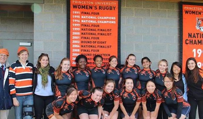 The 2013 Princeton 7s team poses in front of banners touting the programs acheivements.