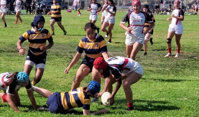 Fallbrook, in white, challenges Belmont Shore for a loose ball.