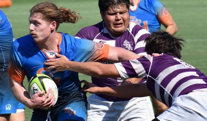 Connor Mackie fends off some attention while playing for Sam Houston State. Photos Courtesy SHSU Rugby.