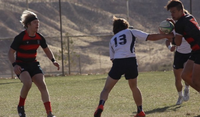 Genesis, in red and black, takes on Snow Canyon. Photo Snow Canyon Rugby.