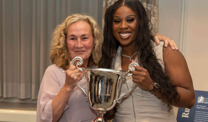 MA Sorensen and Idea Ihensekhien with the trophy that bears Sorensen's name at the Washington Athletic Club.