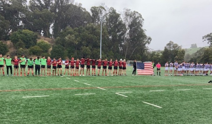 Jesut at left, and St. Augustine, at right, line up for the anthem before the game.