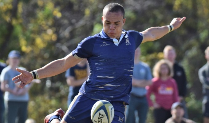 Lewis Gray boots the ball during Navy's win over Army on Saturday. David Hughes photo.  