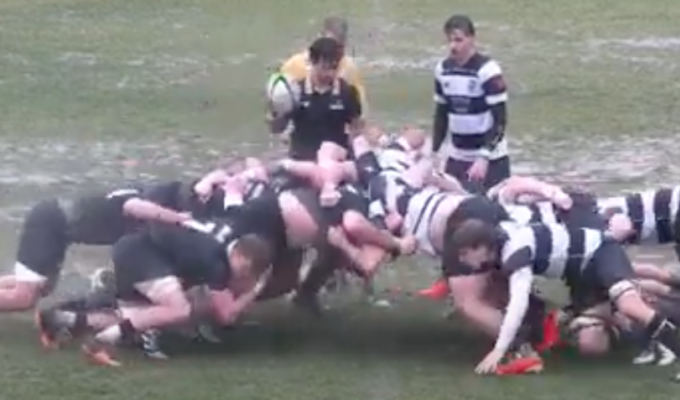 A soggy scrum. (Photo screen grab from YouTube Live Stream.)