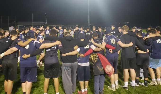 Marina and Servite players gather post-match.