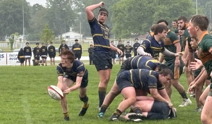 A big day in difficult conditions for Marquette scrumhalf Sam Beck. Photo Marquette HS Rugby.