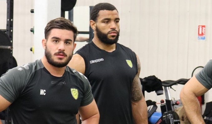 Deion Mikesell, the one on the right, in the Carcassone club weight room.