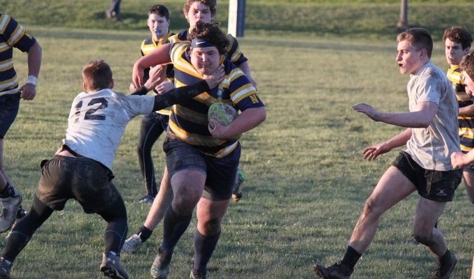 Andrew Cohen charges ahead for Neuqua while David Jensen moves in to make the tackle. 