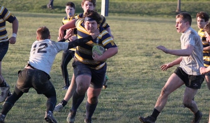 Andrew Cohen charges ahead for Neuqua while David Jensen moves in to make the tackle. 