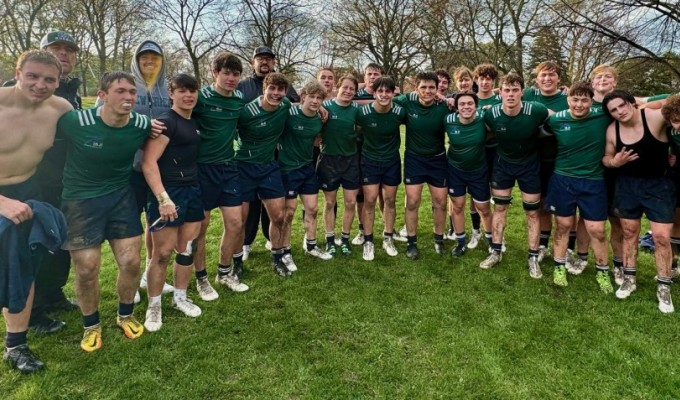 New Trier huddles up after their win. 