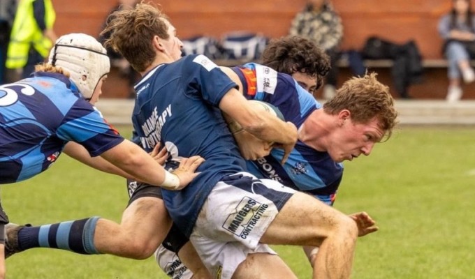 Oliver Kirk works his way through a tackle vs St. Andrews.