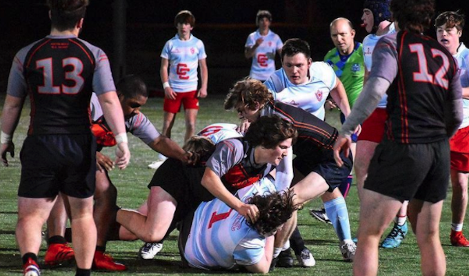 South Meck, in black and red, takes on Charlotte Catholic under the lights. Photo courtesy South Meck Rugby Instagram.