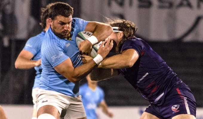 Jason Damm makes a tackle on Santiago Civetta.