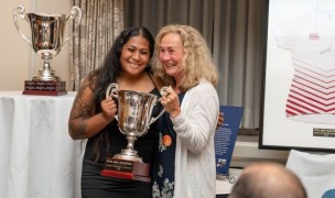2023 winner Mae Sagapolu receives her trophy from fellow prop MA Sorensen. Emilio Huertas photo for Washington Athletic Club.