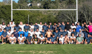 From the 2024 game; both teams pose post-match.