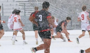 Cavemen in black and red, and East in white and red, in some very white precipitation.