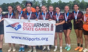 Charlotte Tigress pose after winning the state games.