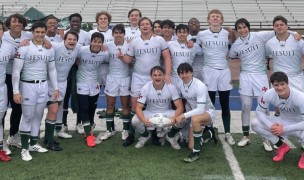 Cold and wet the Strake Jesuit players celebrate a first-ever win over Dallas Jesuit.