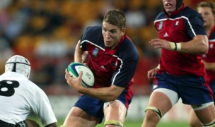 Dan Lyle takes on a Fijian defender in the 2003 Rubgy World Cup. Photo Rugby World Cup.