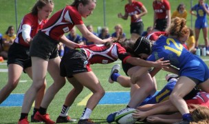 DSHA in red works the ruck against Catholic Memorial.