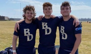 Bishop Dwenger players Mike Tippmann, John Michael Fabini, and Joe Fabini are happy after their victory.