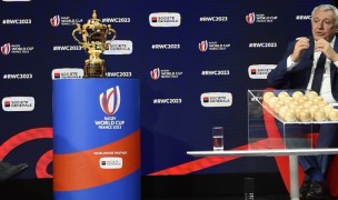 Claude Atcher on stage during the RWC Draw reveal December 15. Aurelien Meunier Getty Images For Rugby World Cup.