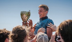 St. Martin's captain Ethan Blakie hoists the trophy.