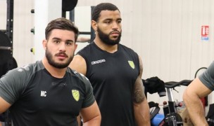 Deion Mikesell, the one on the right, in the Carcassone club weight room.