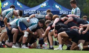 UNCW (in stripes) packs down vs NC State (in red and black). 