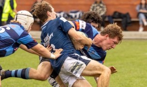 Oliver Kirk works his way through a tackle vs St. Andrews.