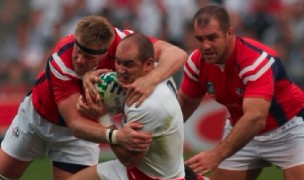 Chris Osentowski is there to steal as Alec Parker makes a tackle against England in the 2007 Rugby World Cup. Ian Muir photo.