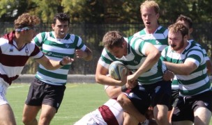 Owen Reinhardt crashes through with Scott Lewis, Brian Sweeney, Scott Lewis, and John Haase for WashU Christine Krug Photo.