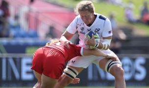 USA captain Kate Zachary fending off a Canadian tackler in 2021 Rugby World Cup. Photo by Fiona Goodall.