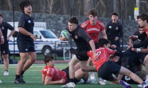 Rye's Harry Hillis carries the rock vs Greenwich. Photo Will Kressler.