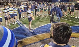 St. Ignatius holds the Cavoli Cup while St. Ignatius Head Coach Dan Arbeznik addresses both teams.