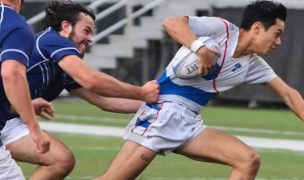 Nathanael Taylor pulling away from tacklers for UMass Lowell.