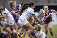 Annekkia Ritter-Truxal with the tackl. Keiani Pangelinan tries to grab the ball. Julianna Aliprandi is running in. Mark Washburn