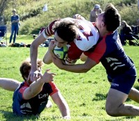 UConn players launch into the tackle. Photo @CoolRugbyPhotos.