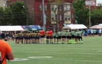 Belmont Shore and Rhinos stand for the National Anthem. Alex Goff photo.