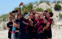 The Berks U19s celebrating on the beach.