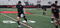 Giannascoli kickes downfield for his chasers. Photo Loyola Rugby.