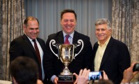 Doug Scholz, left, Dave Scholz, right, with Jon McNerney, the father of 2018 Scholz Award-winner Connor McNerney. 