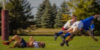 Aiden Reilly powers over a defender to score.